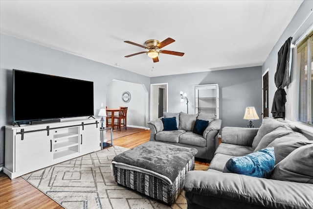 living room with ceiling fan and light wood-type flooring