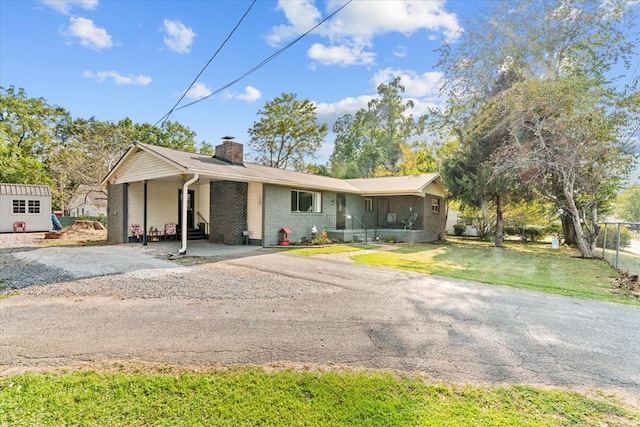 ranch-style home featuring a front yard