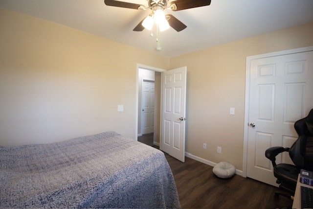 bedroom featuring ceiling fan, baseboards, and dark wood finished floors