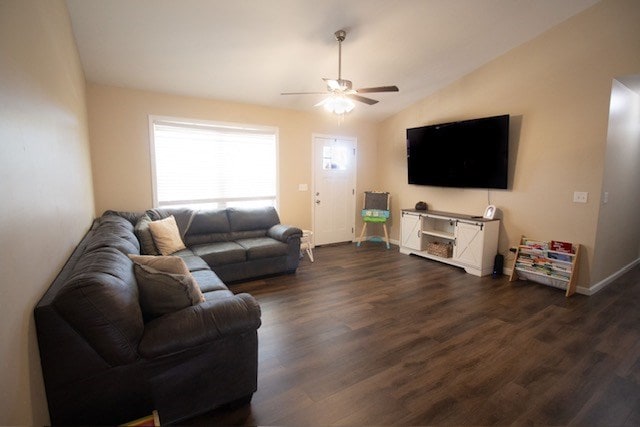 living area featuring baseboards, lofted ceiling, dark wood finished floors, and a ceiling fan