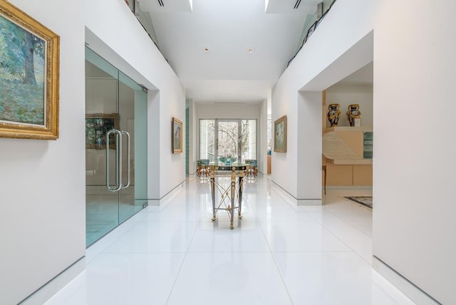 hall with light tile patterned floors