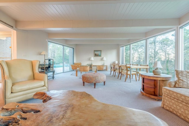 living room featuring beam ceiling and carpet