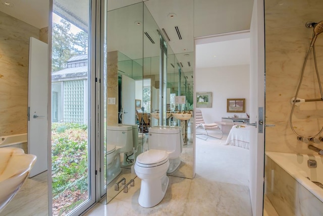 bathroom featuring bathing tub / shower combination and toilet