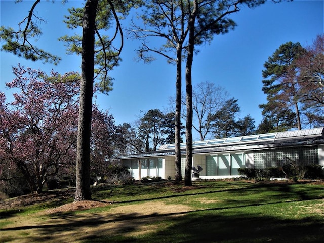 view of property exterior with a lawn