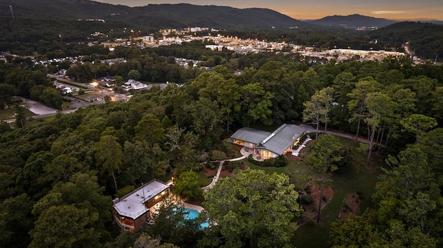 aerial view at dusk featuring a mountain view