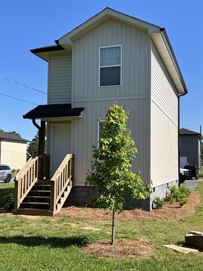 rear view of house with a lawn