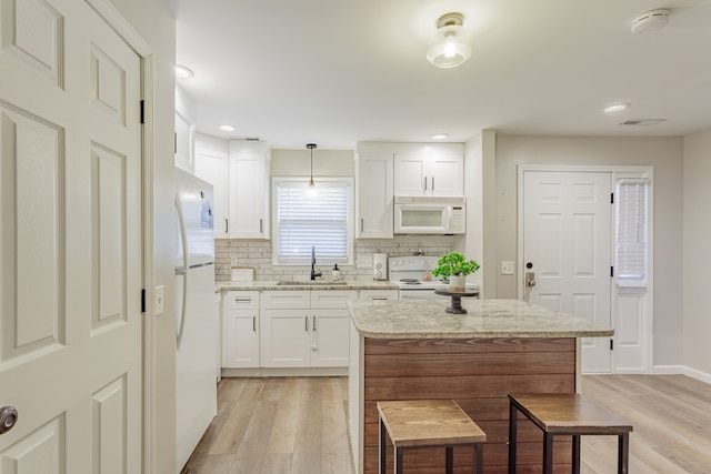 1900 Meadowbrook Cir, Dalton, GA 30720 - kitchen with white appliances, a sink, light wood finished floors, white cabinets, and decorative backsplash