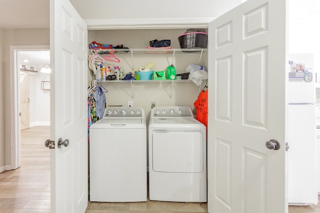 1900 Meadowbrook Cir, Dalton, GA 30720 - laundry area featuring washer and clothes dryer, light wood-type flooring, and baseboards