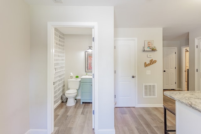 1900 Meadowbrook Cir, Dalton, GA 30720 - bathroom featuring vanity, wood finished floors, toilet, and baseboards