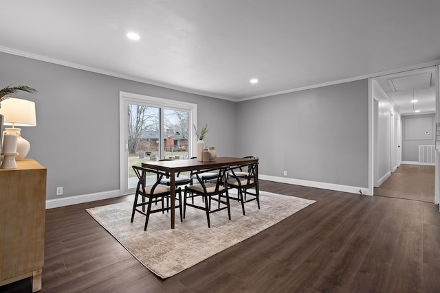 dining room with attic access, ornamental molding, baseboards, dark wood-type flooring, and recessed lighting