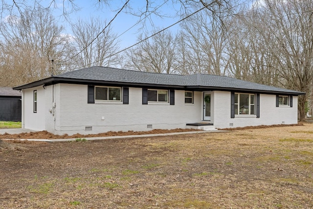 ranch-style home featuring crawl space, brick siding, and roof with shingles
