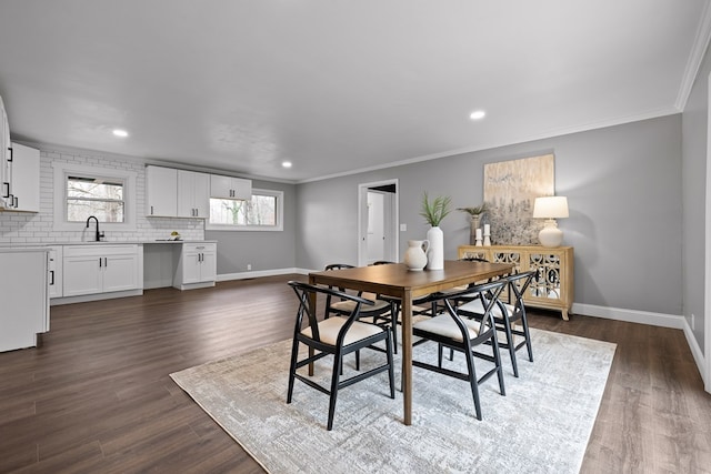 dining area featuring baseboards, dark wood finished floors, ornamental molding, and recessed lighting