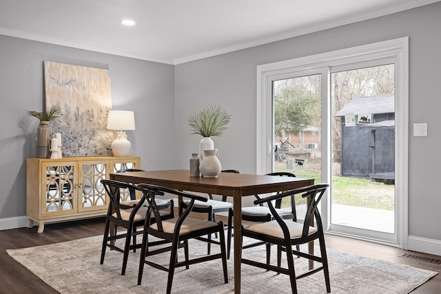 dining area with crown molding, baseboards, dark wood finished floors, and recessed lighting