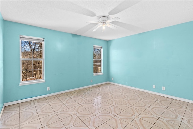 spare room with ceiling fan and a textured ceiling