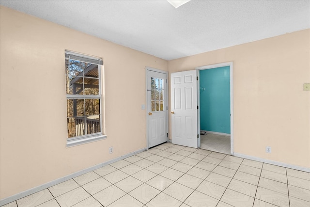 unfurnished room with a wealth of natural light and a textured ceiling