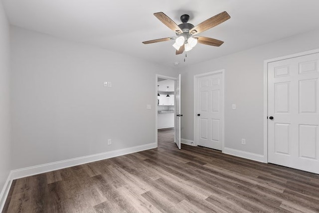 unfurnished bedroom with ceiling fan and dark hardwood / wood-style floors