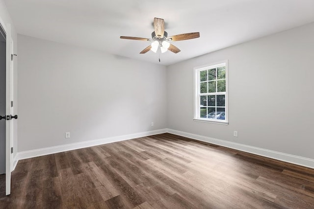 empty room with dark wood-type flooring and ceiling fan