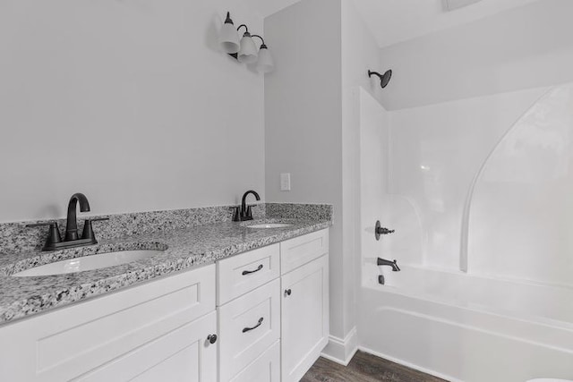 bathroom featuring vanity, hardwood / wood-style floors, and bathing tub / shower combination