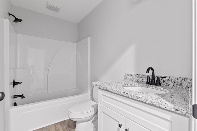 full bathroom with vanity, toilet,  shower combination, and wood-type flooring