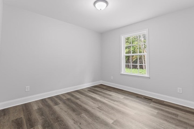 unfurnished room featuring dark wood-type flooring