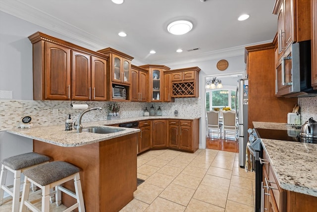 604 Lenna Ln, Dalton, GA 30720 - kitchen featuring appliances with stainless steel finishes, a sink, a peninsula, brown cabinetry, and crown molding