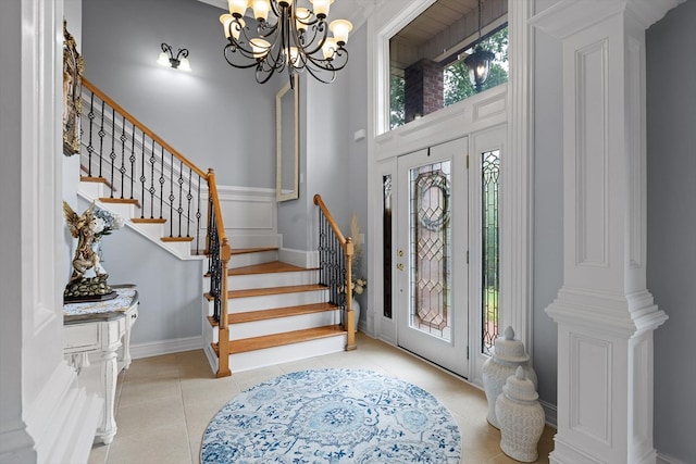 604 Lenna Ln, Dalton, GA 30720 - entrance foyer with a chandelier, stairs, light tile patterned flooring, and baseboards