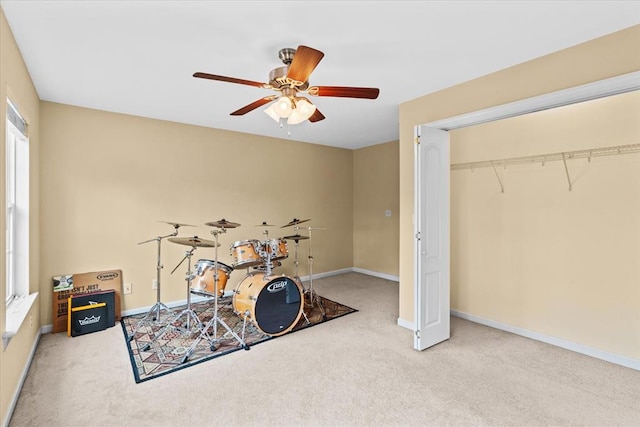 rec room with carpet floors and ceiling fan