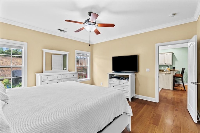 bedroom featuring hardwood / wood-style flooring, ceiling fan, and ornamental molding