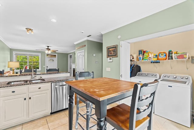 kitchen featuring light tile patterned flooring, sink, dishwasher, independent washer and dryer, and white cabinets