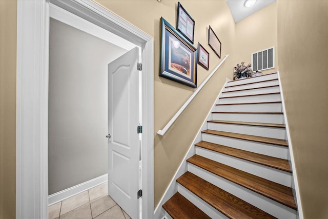 stairway with tile patterned floors