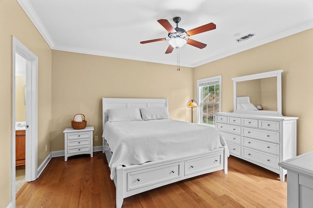 bedroom with light hardwood / wood-style flooring, ornamental molding, and ceiling fan