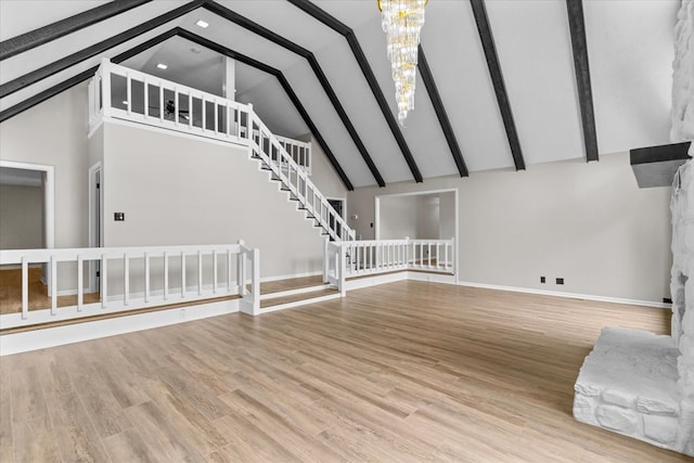 2219 Rocky Face Cir, Dalton, GA 30740 - unfurnished living room featuring high vaulted ceiling, a chandelier, stairs, beamed ceiling, and wood finished floors