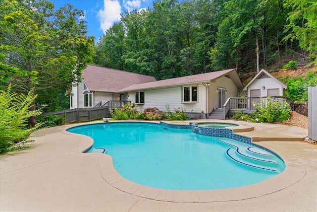 2219 Rocky Face Cir, Dalton, GA 30740 - view of swimming pool featuring an outbuilding, a wooden deck, a pool with connected hot tub, and a patio area