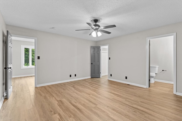 2219 Rocky Face Cir, Dalton, GA 30740 - unfurnished bedroom featuring light wood finished floors, a textured ceiling, ensuite bathroom, and ceiling fan