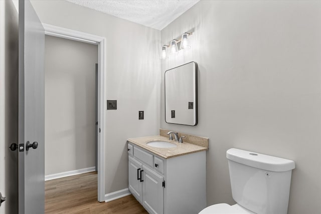 2219 Rocky Face Cir, Dalton, GA 30740 - half bathroom with vanity, wood finished floors, and a textured ceiling