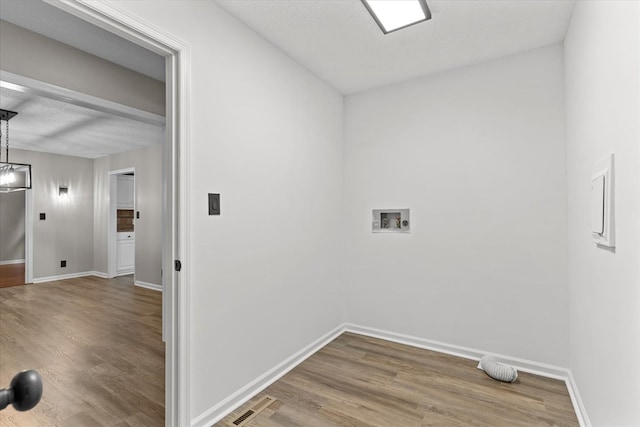 2219 Rocky Face Cir, Dalton, GA 30740 - washroom featuring wood finished floors, washer hookup, and a chandelier