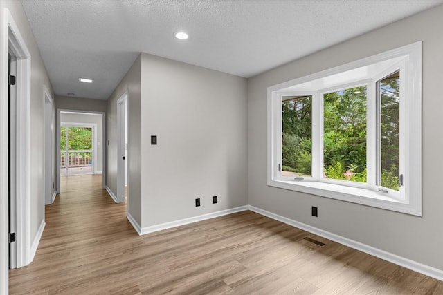 2219 Rocky Face Cir, Dalton, GA 30740 - unfurnished room with light wood-style flooring, a textured ceiling, and recessed lighting