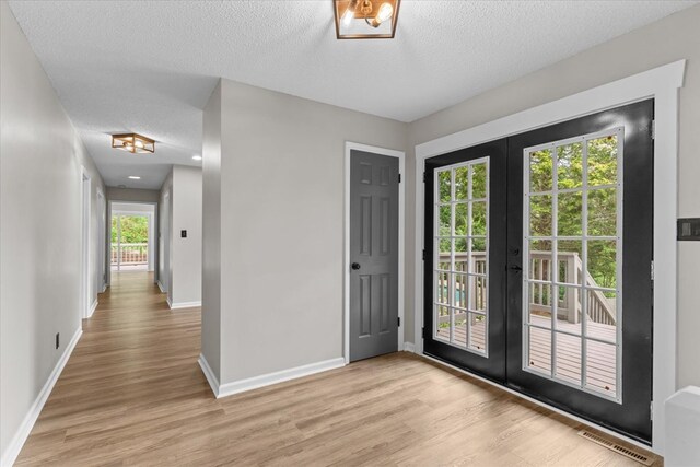 2219 Rocky Face Cir, Dalton, GA 30740 - doorway featuring french doors, light wood-style floors, and a textured ceiling