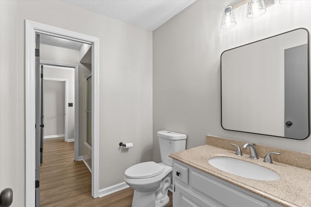 2219 Rocky Face Cir, Dalton, GA 30740 - full bath with vanity, a textured ceiling, wood finished floors, and shower / bath combination with glass door