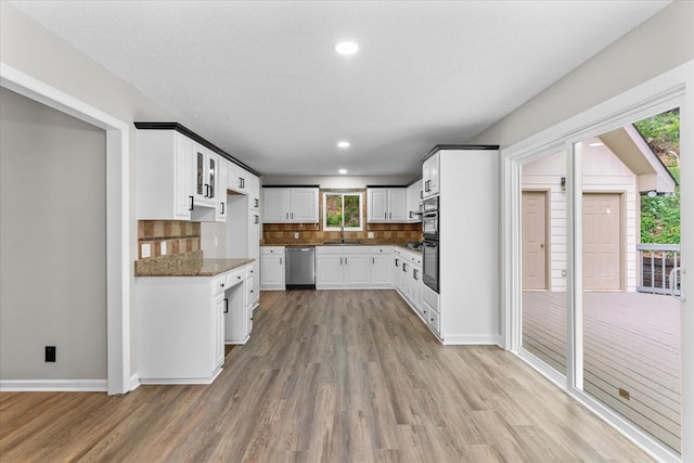 2219 Rocky Face Cir, Dalton, GA 30740 - kitchen featuring dishwasher, light wood-style flooring, tasteful backsplash, white cabinetry, and recessed lighting
