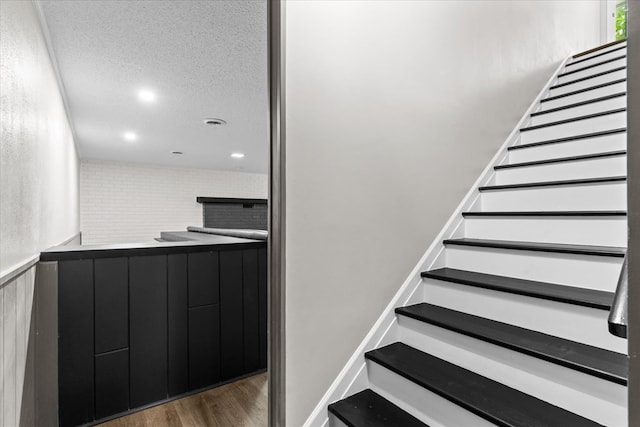 2219 Rocky Face Cir, Dalton, GA 30740 - staircase with wood finished floors, a textured ceiling, and recessed lighting