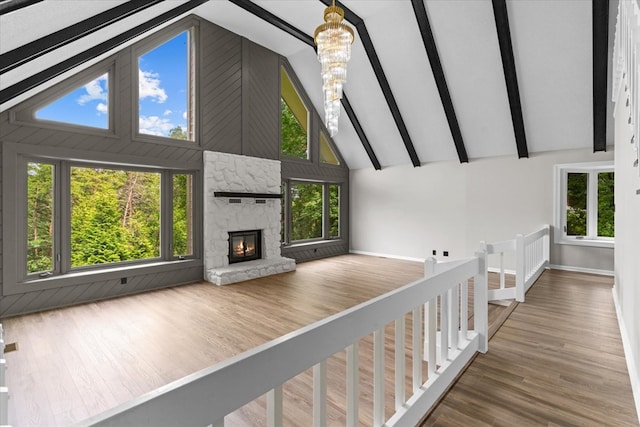 2219 Rocky Face Cir, Dalton, GA 30740 - unfurnished living room featuring high vaulted ceiling, a fireplace, wood finished floors, healthy amount of natural light, and beamed ceiling
