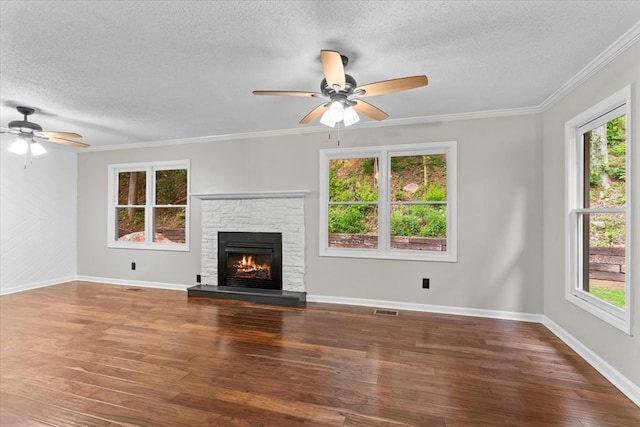 2219 Rocky Face Cir, Dalton, GA 30740 - unfurnished living room with ceiling fan, a textured ceiling, wood finished floors, a stone fireplace, and crown molding