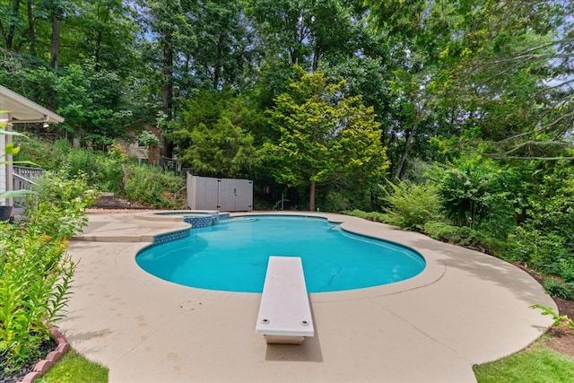 2219 Rocky Face Cir, Dalton, GA 30740 - view of pool with a diving board, a pool with connected hot tub, a patio area, and view of wooded area
