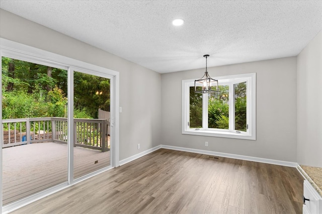 2219 Rocky Face Cir, Dalton, GA 30740 - empty room featuring wood finished floors, a textured ceiling, a chandelier, and recessed lighting