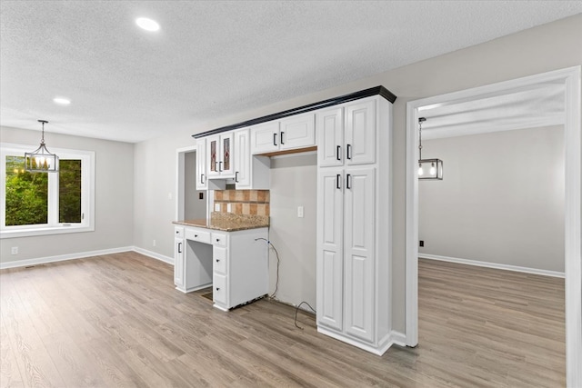 2219 Rocky Face Cir, Dalton, GA 30740 - kitchen with a textured ceiling, light wood-style floors, white cabinetry, recessed lighting, and tasteful backsplash
