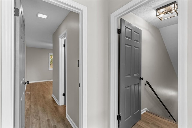 2219 Rocky Face Cir, Dalton, GA 30740 - hall with an upstairs landing, wood finished floors, and a textured ceiling