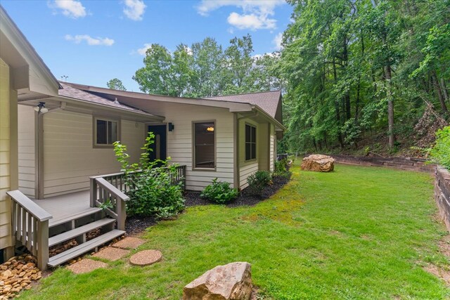 2219 Rocky Face Cir, Dalton, GA 30740 - view of side of property with a lawn, a wooden deck, and a shingled roof