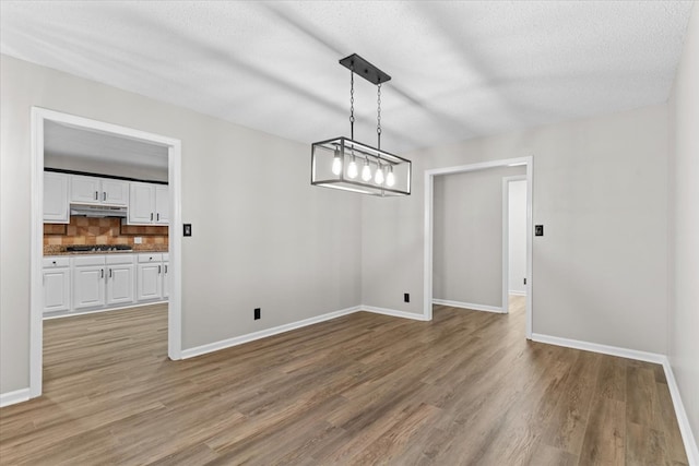 2219 Rocky Face Cir, Dalton, GA 30740 - unfurnished dining area with light wood-type flooring and a textured ceiling