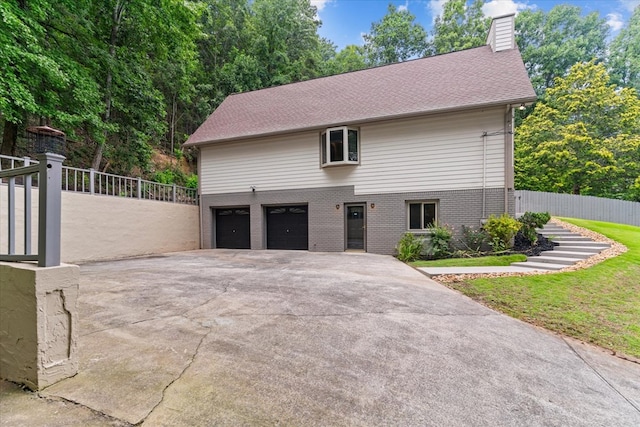 2219 Rocky Face Cir, Dalton, GA 30740 - view of front of property with concrete driveway, brick siding, a chimney, and a garage